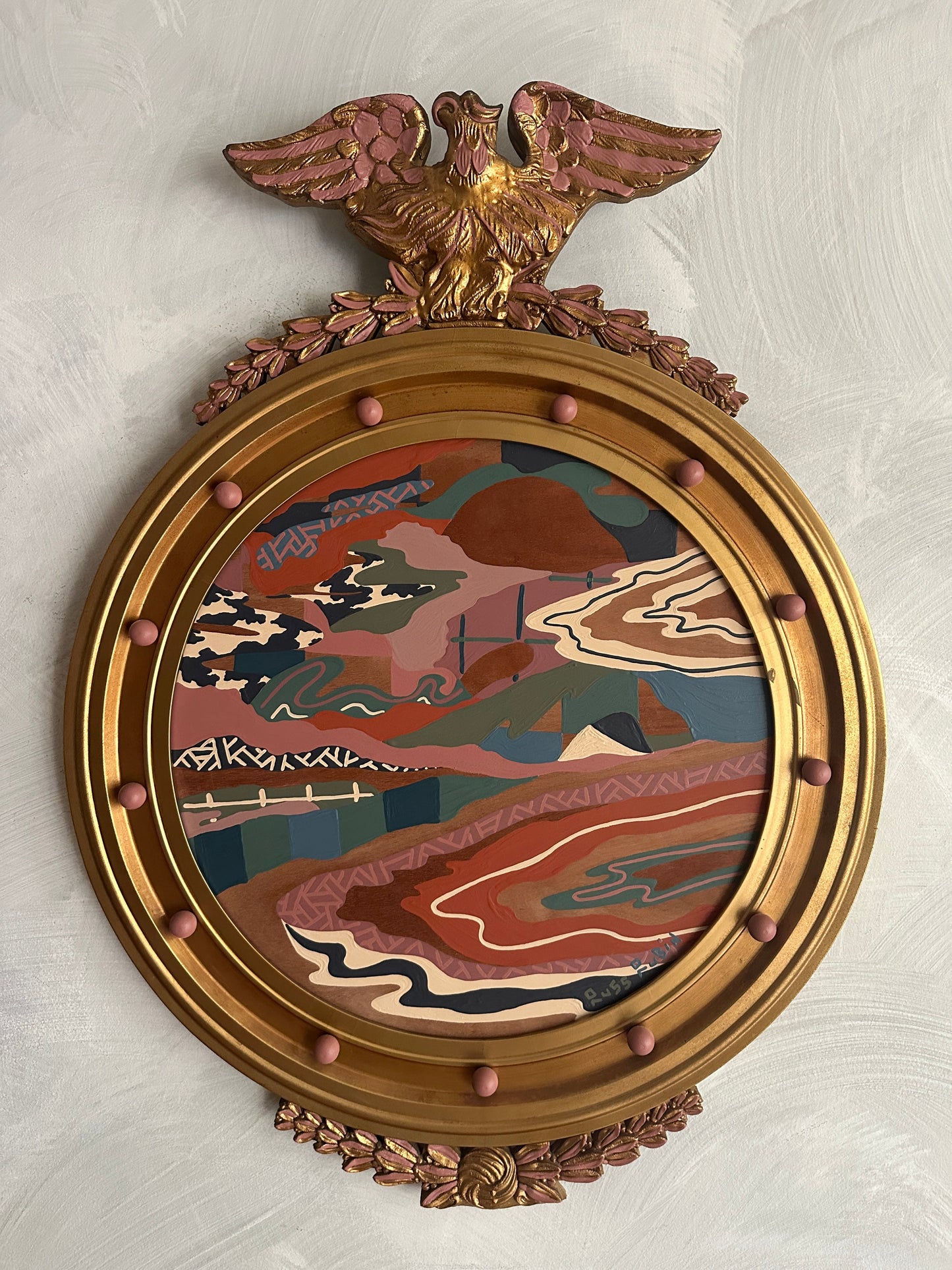 Abstract landscape painting on wood in vintage eagle frame by Russ Rubin - front view on wall