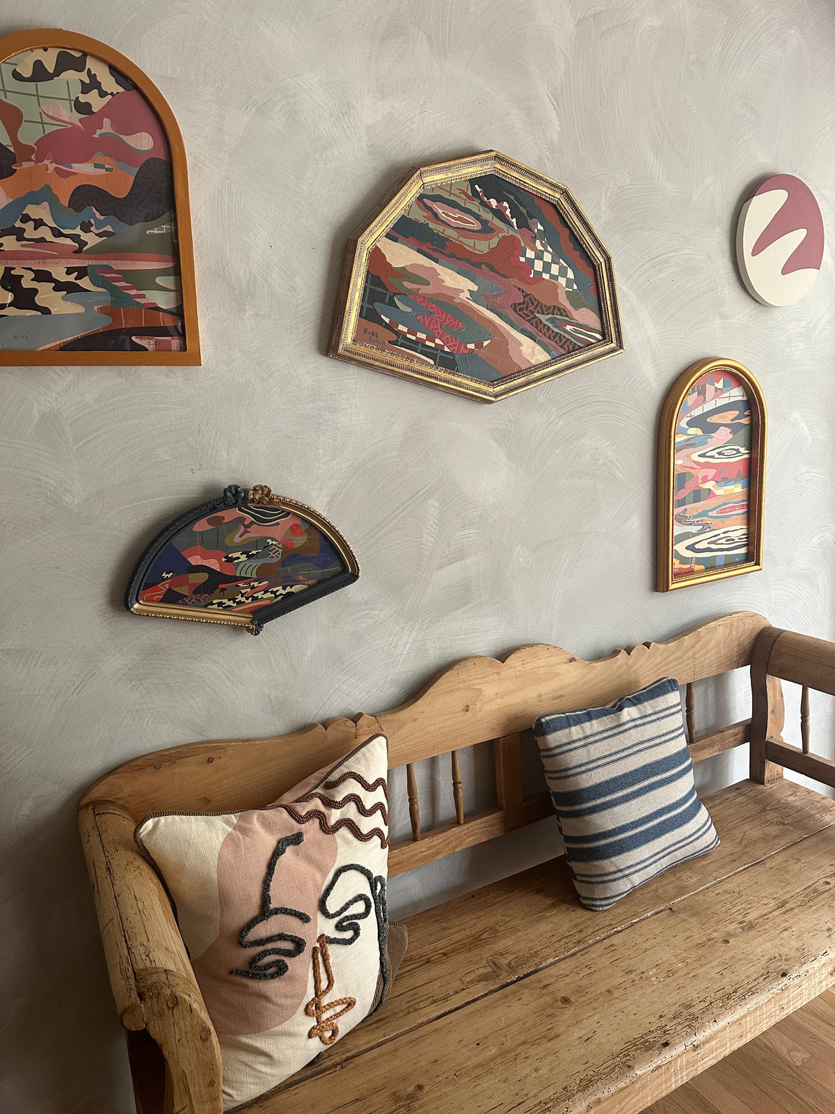 Abstract landscape painting on wood in vintage frame by Russ Rubin - angle view on wall with other art