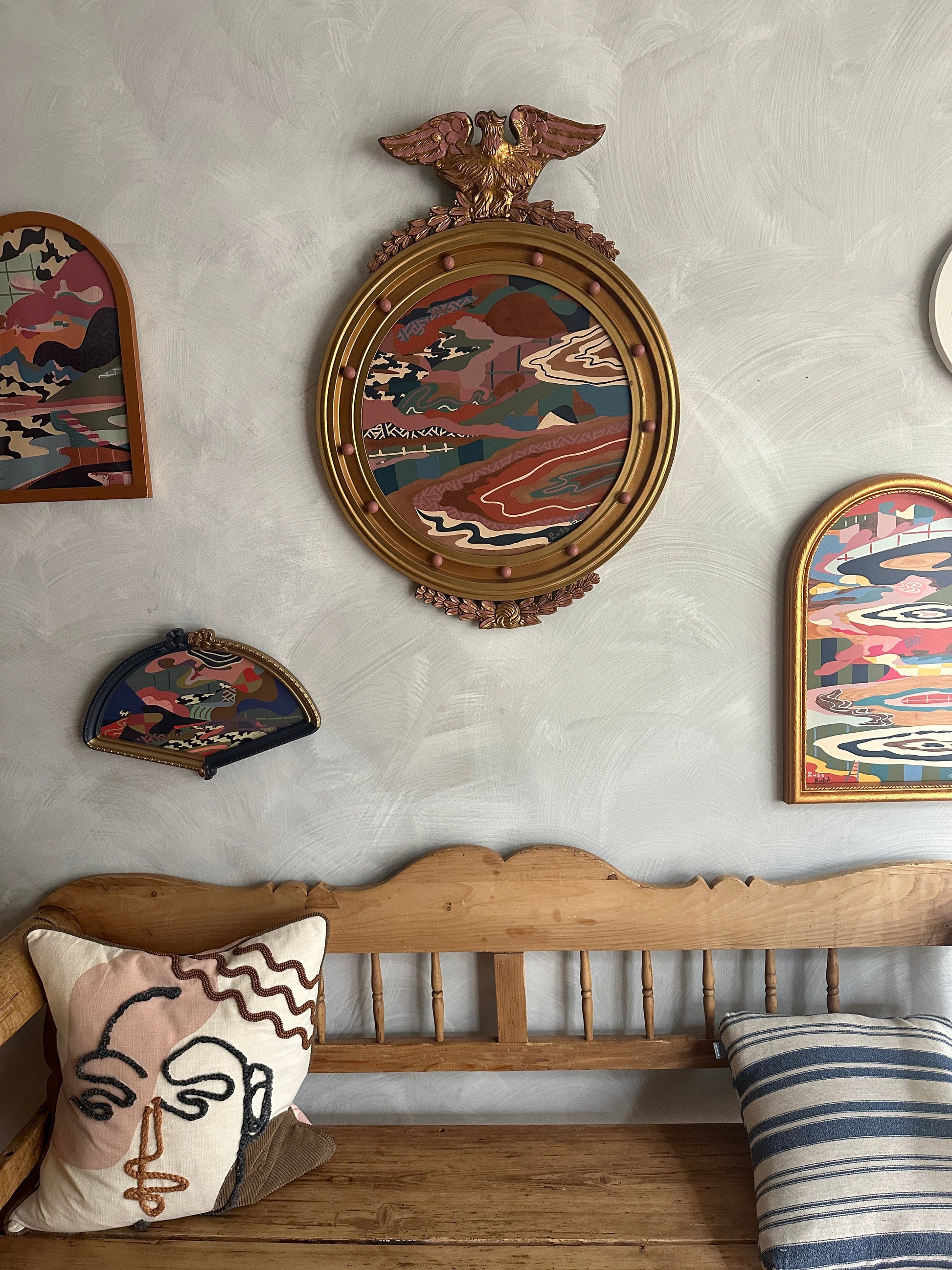 Abstract landscape painting on wood in vintage eagle frame by Russ Rubin - front view on wall with other art