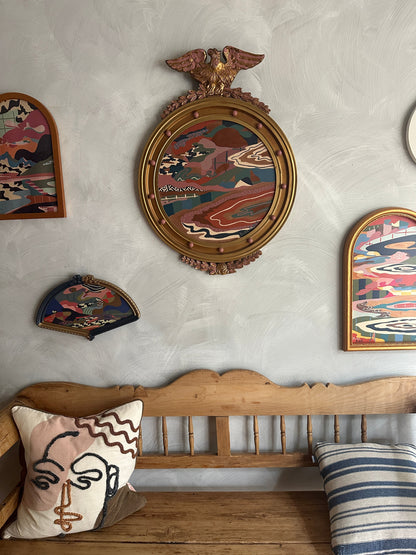 Abstract landscape painting on wood in vintage eagle frame by Russ Rubin - front view on wall with other art