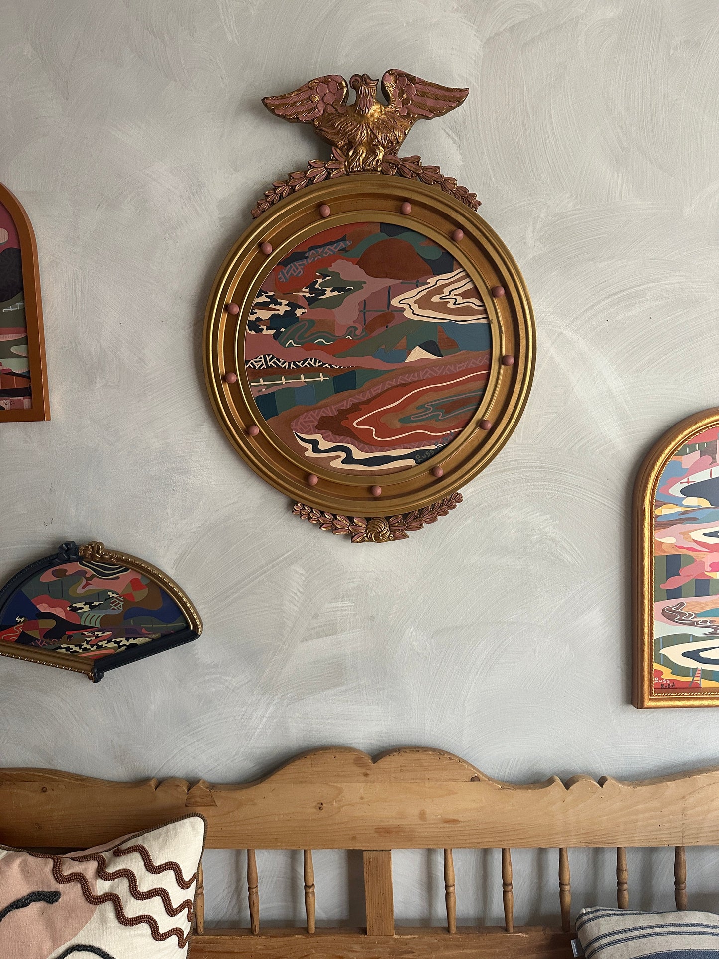 Abstract landscape painting on wood in vintage eagle frame by Russ Rubin - front view on wall with other art