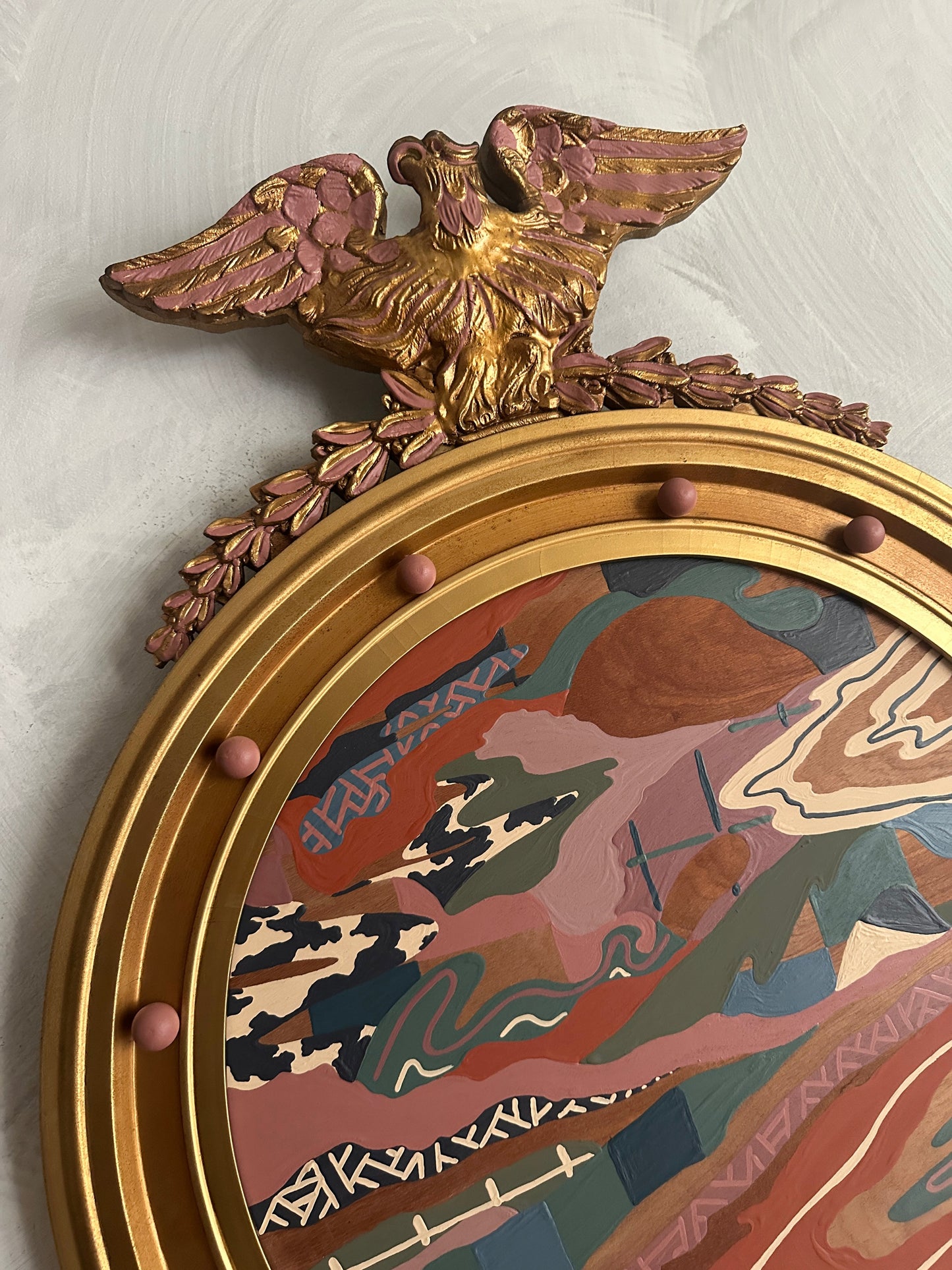 Abstract landscape painting on wood in vintage eagle frame by Russ Rubin - angle detail view on wall 