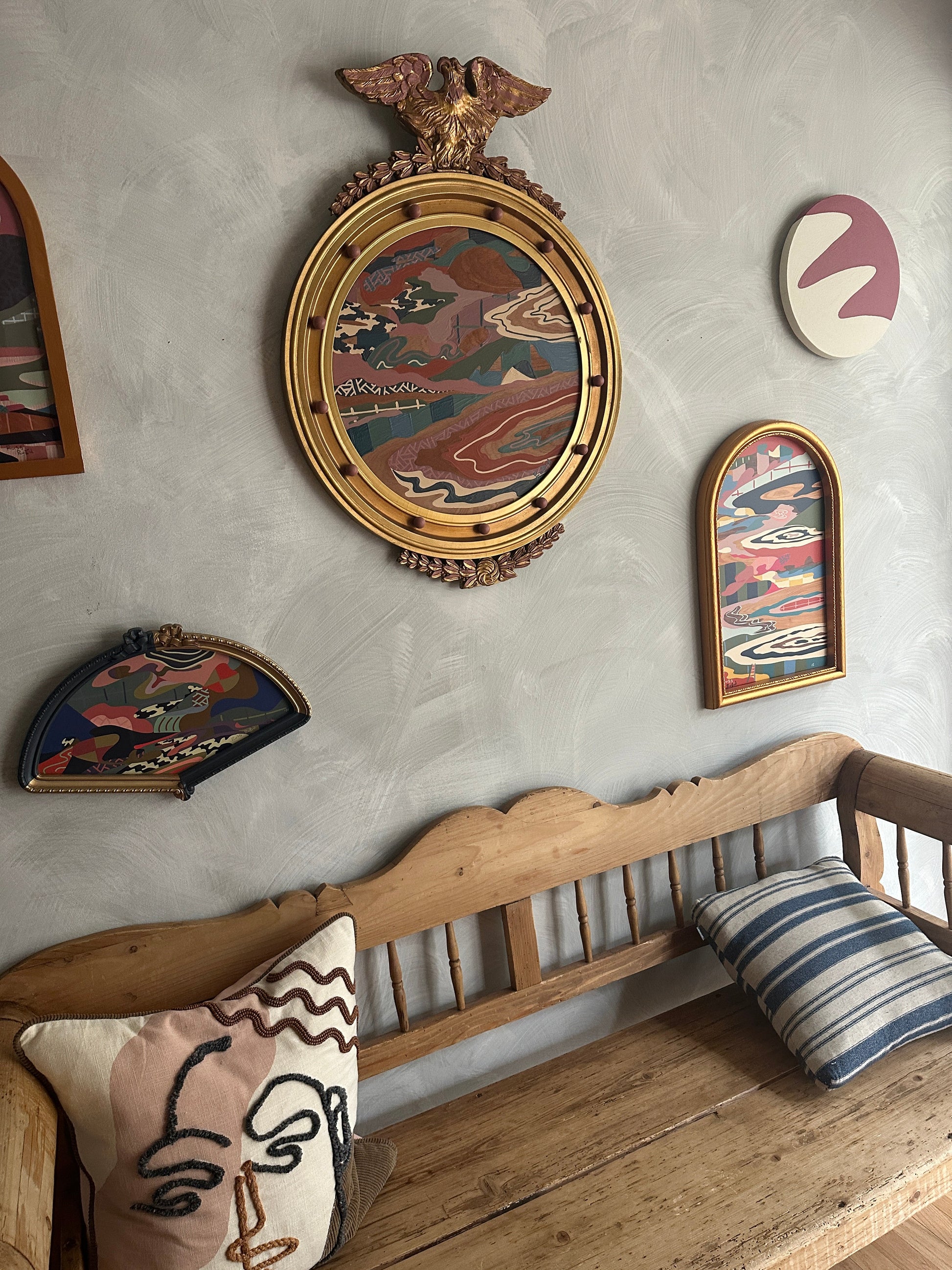 Abstract landscape painting on wood in vintage eagle frame by Russ Rubin - angle view on wall with other art