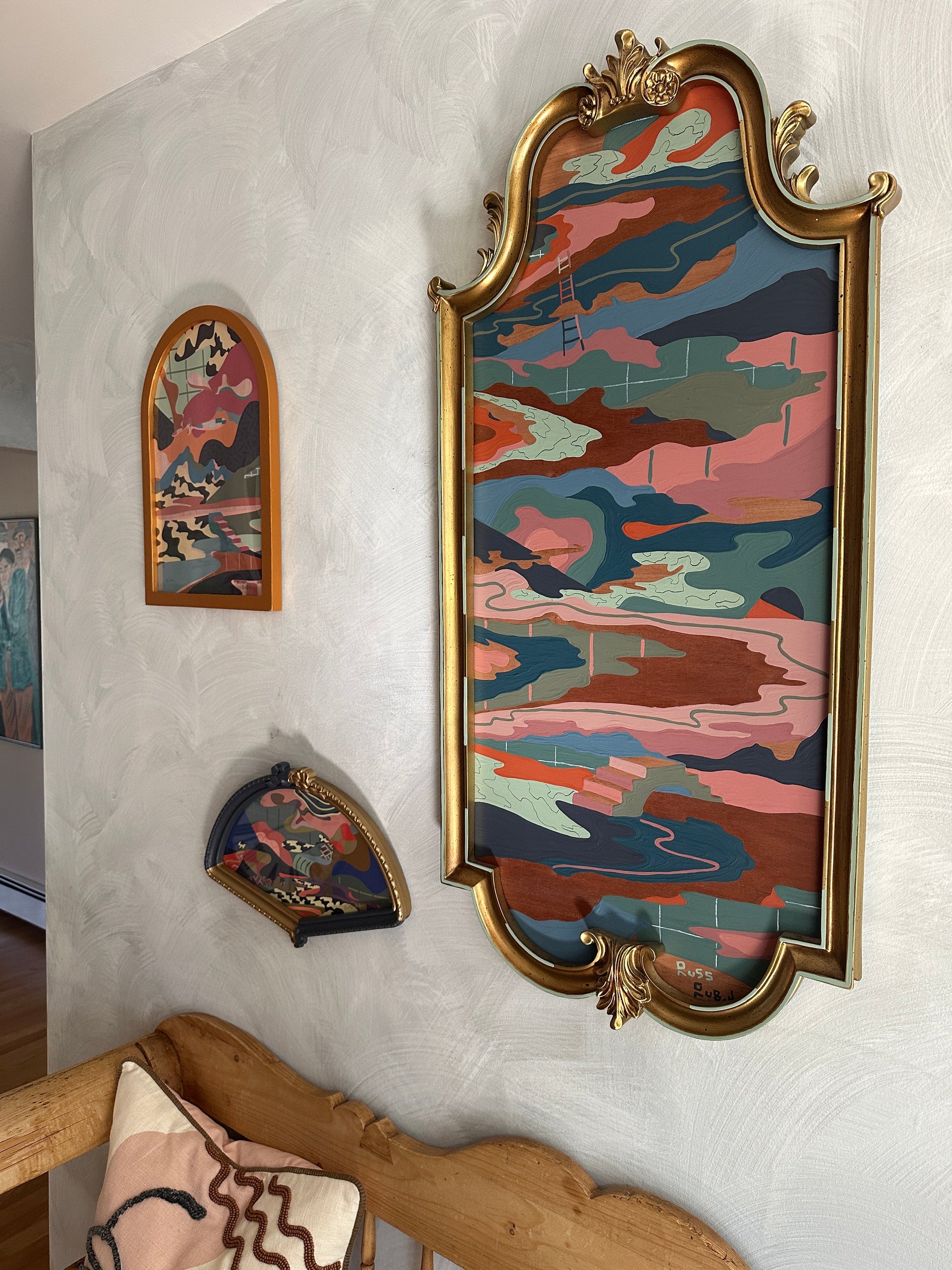 Abstract landscape on wood in vintage frame by Russ Rubin - angle view on wall with other art