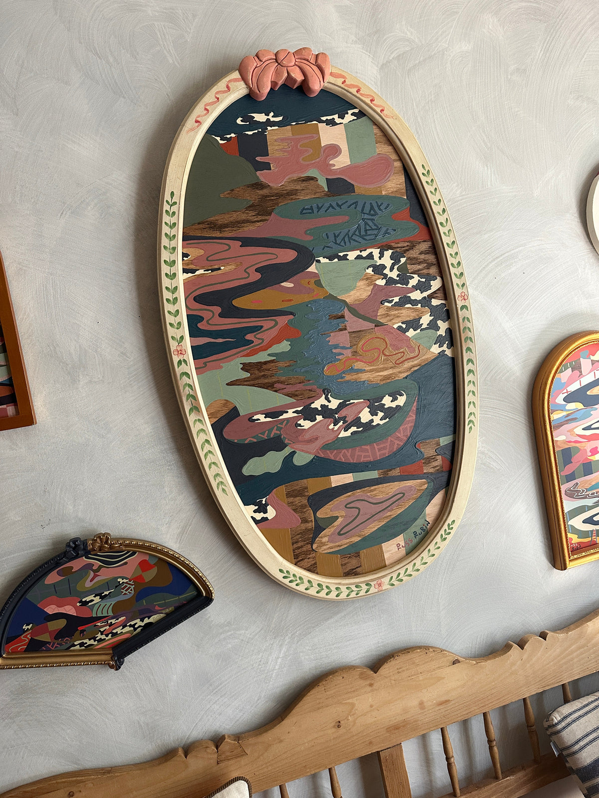 Abstract landscape on wood in vintage frame by Russ Rubin - angle view on wall with other art