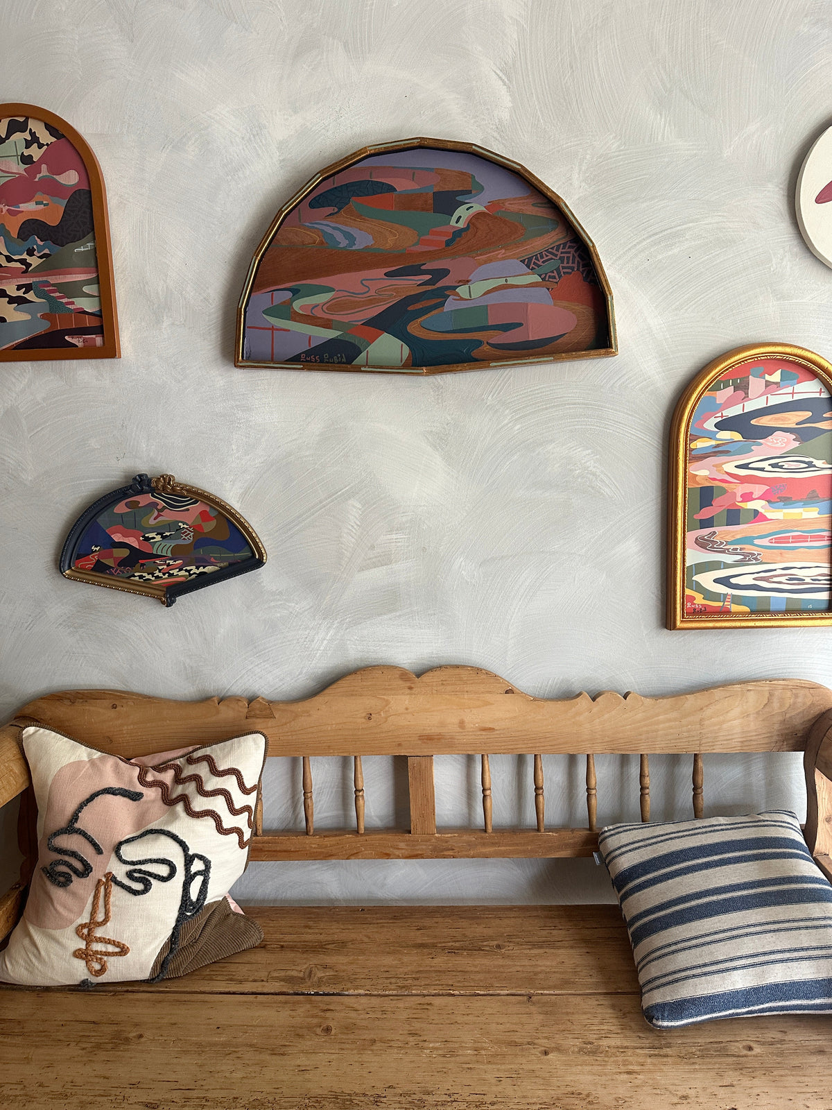 Abstract landscape painting on wood in fan shaped frame by Russ Rubin - on wall with other art