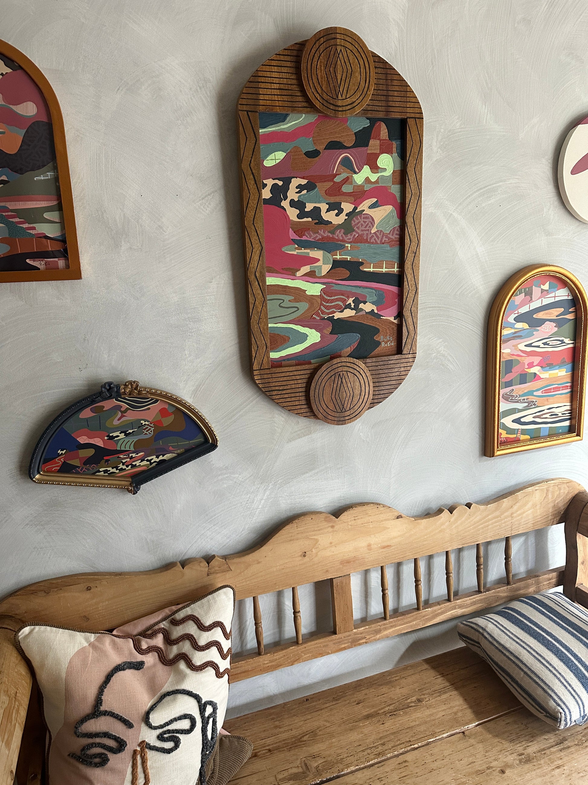 Abstract landscape painting on wood in vintage frame by Russ Rubin - angle view on wall with other art