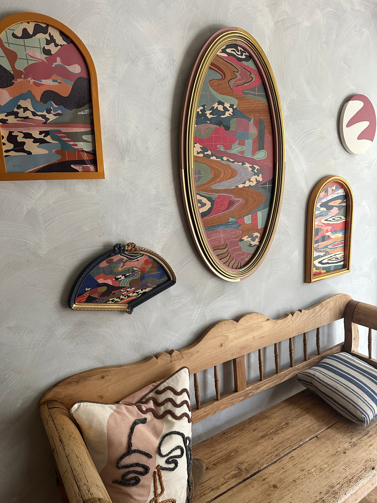 Abstract landscape painting on wood in vintage frame by Russ Rubin - angle view on wall with other art