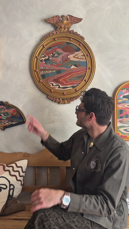 Russ Rubin discussing his abstract landscape painting on wood in vintage eagle frame 