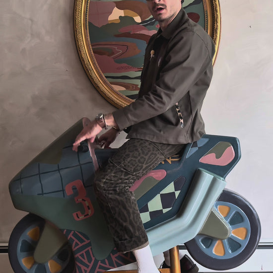Russ Rubin discussing his hand painted motorcycle kiddie ride